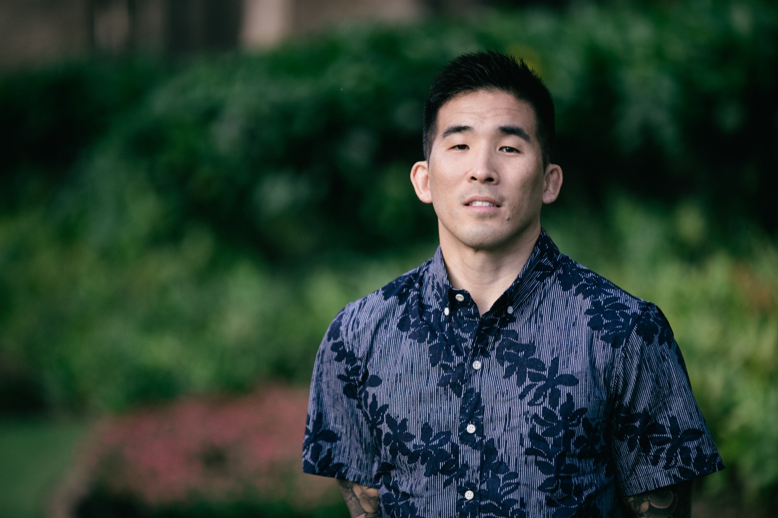 Tim Hirata in a navy aloha shirt, outdoors